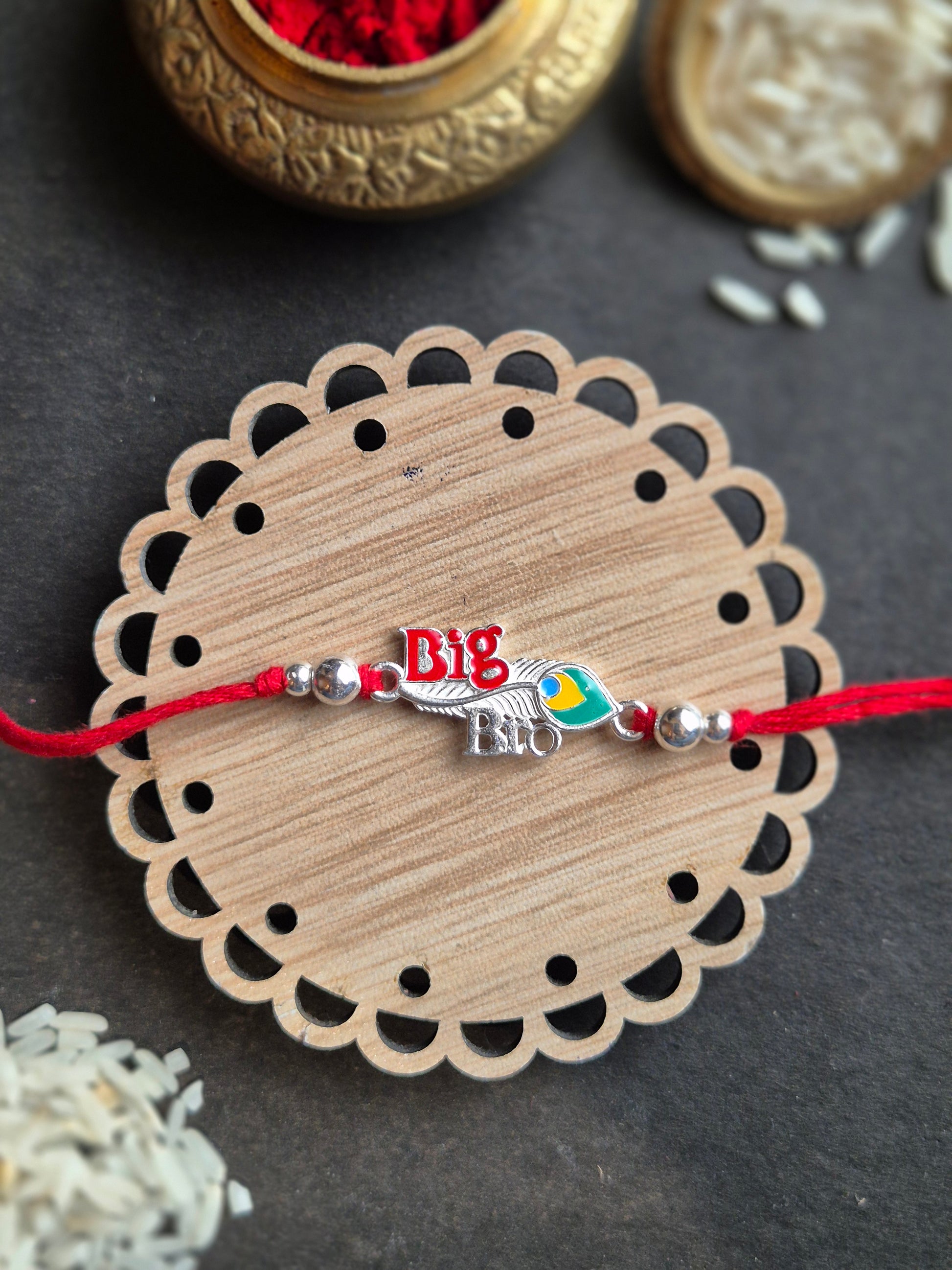 Big Bro Sterling Silver Rakhi with vibrant feather, handmade jewelry for Raksha Bandhan. A symbol of affection and love.